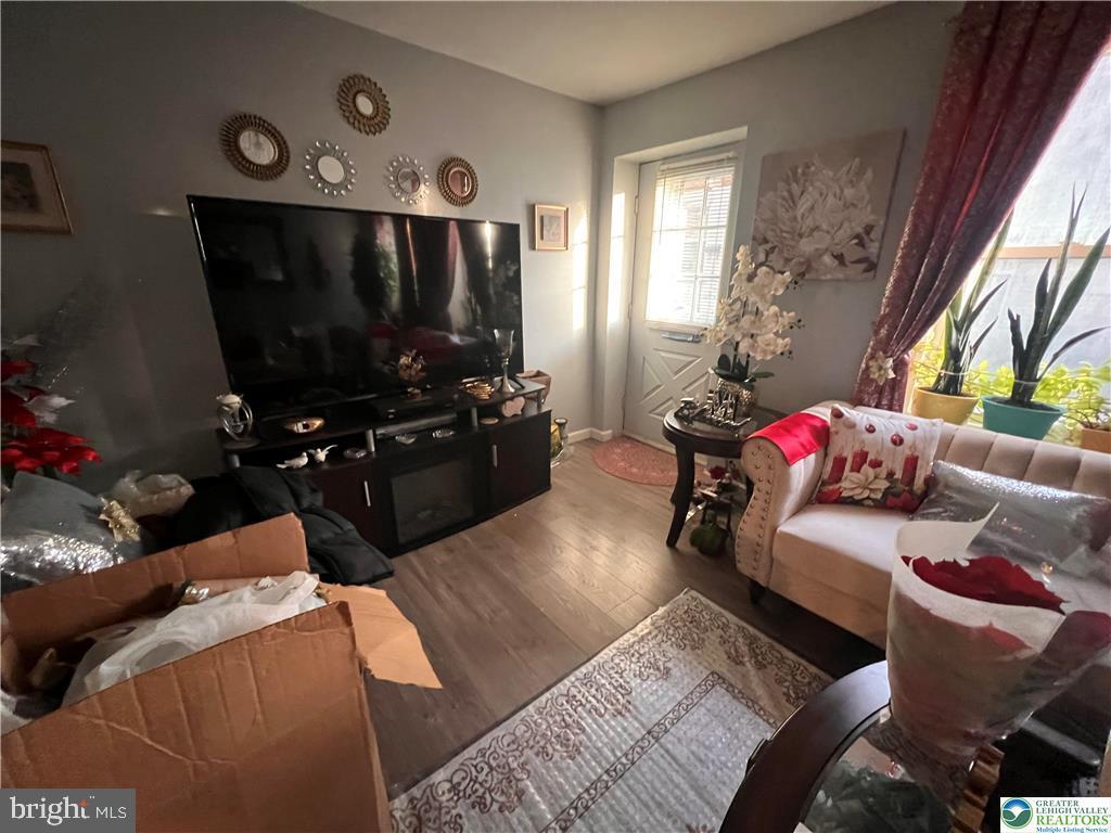 735 Laufer Street Bethlehem, PA 18015 - Photo 5 of 22 a living room with furniture a flat screen tv and a floor to ceiling window