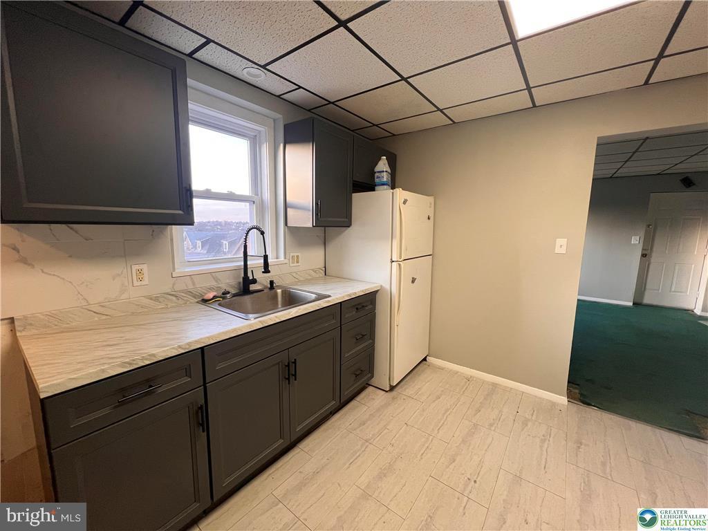 735 Laufer Street Bethlehem, PA 18015 - Photo 9 of 22 a kitchen with a sink cabinets and a refrigerator