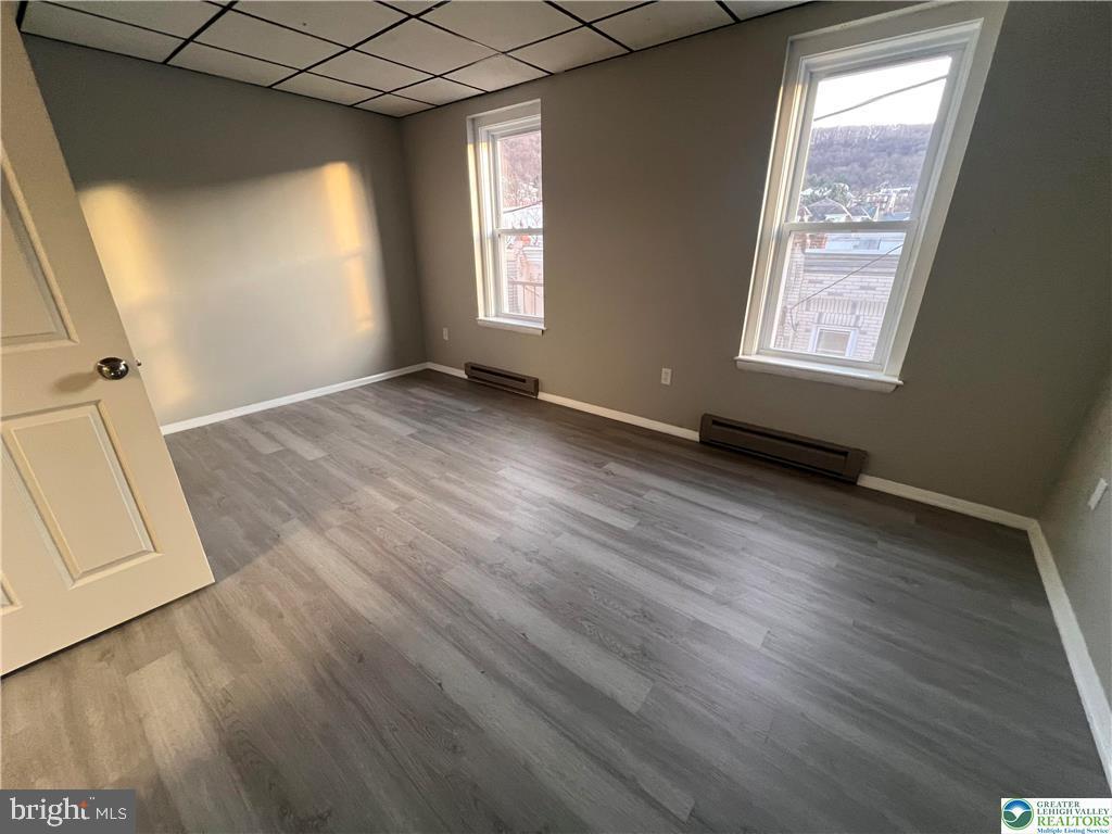 735 Laufer Street Bethlehem, PA 18015 - Photo 10 of 22 an empty room with wooden floor and windows
