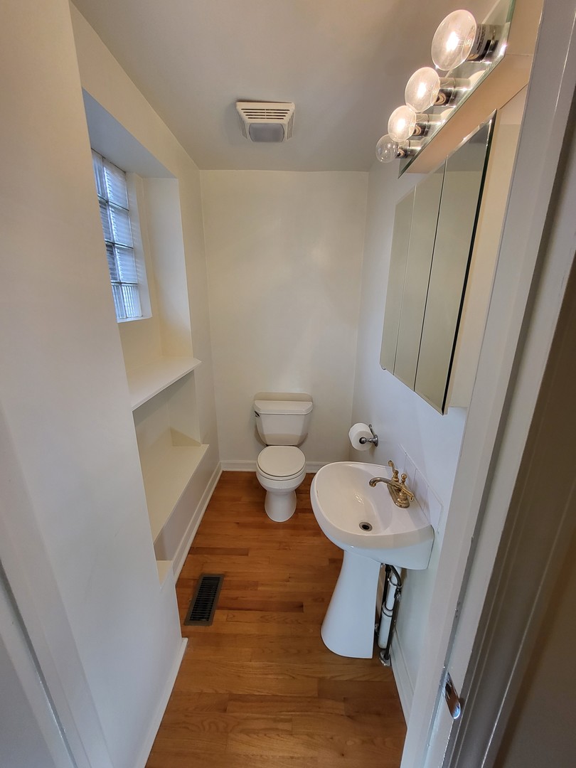 Undisclosed Address Chicago, IL 60622 - Photo 11 of 15 a bathroom with a sink mirror and toilet