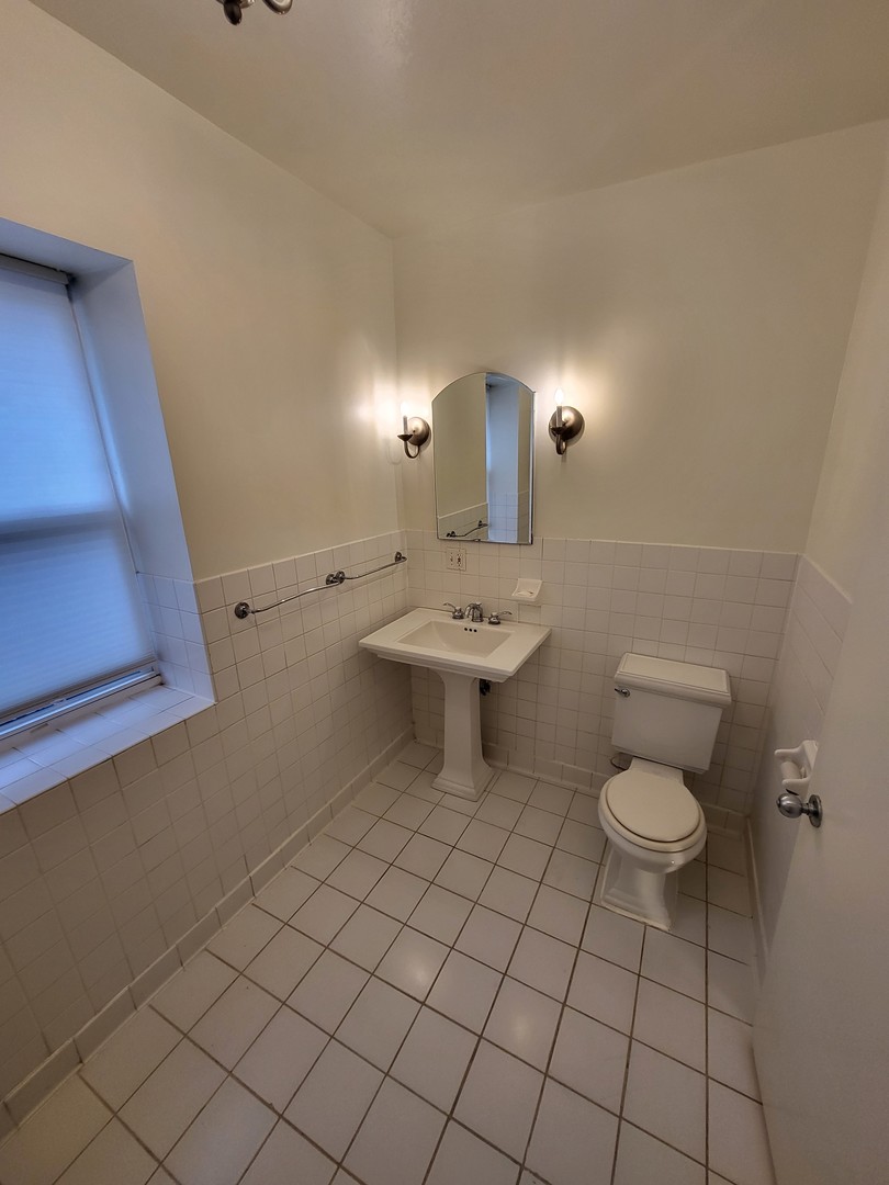 Undisclosed Address Chicago, IL 60622 - Photo 13 of 15 a bathroom with a toilet a sink and mirror