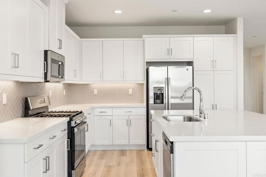 5384 Viewstone Court Hemet, CA 92545 - Photo 13 of 47 a kitchen with stainless steel appliances granite countertop a sink stove and cabinets