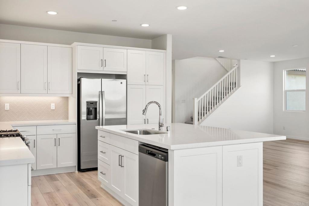 5384 Viewstone Court Hemet, CA 92545 - Photo 14 of 47 a kitchen with white cabinets and sink