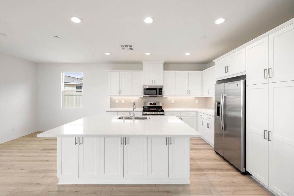 5384 Viewstone Court Hemet, CA 92545 - Photo 15 of 47 a kitchen with stainless steel appliances a refrigerator sink and microwave
