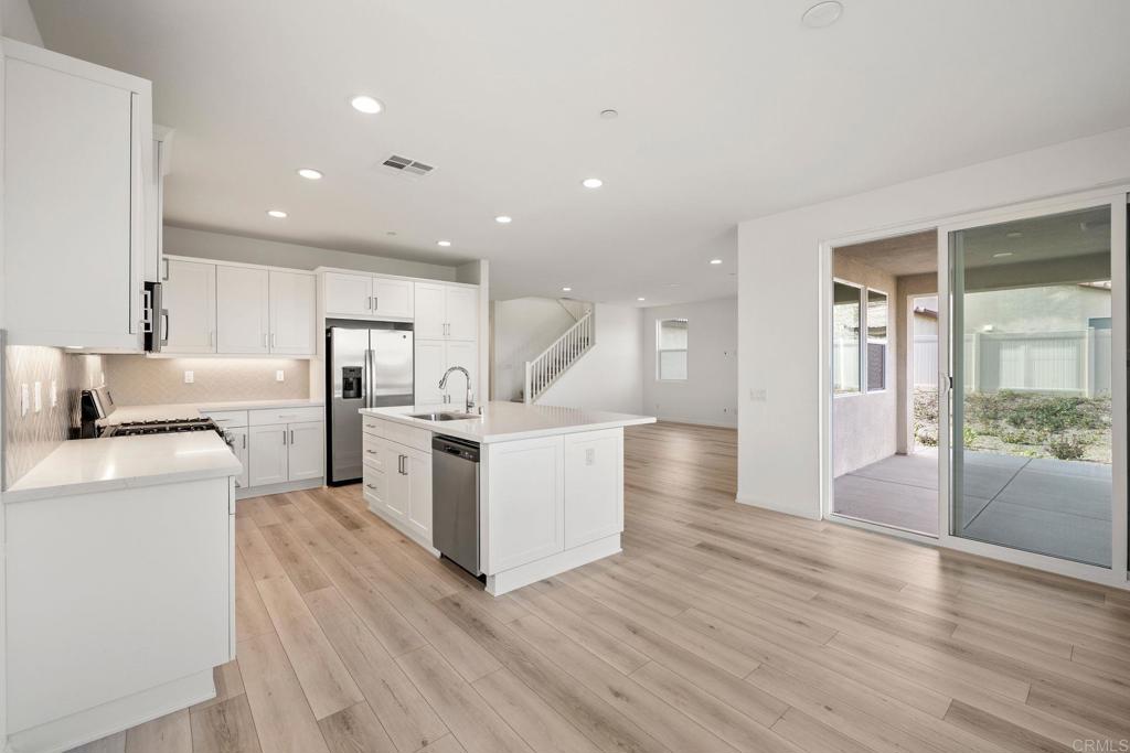 5384 Viewstone Court Hemet, CA 92545 - Photo 16 of 47 a view of a kitchen with refrigerator and wooden floor