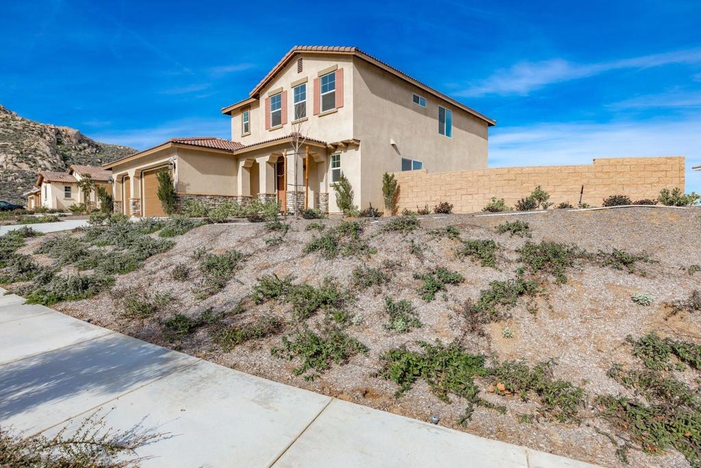 5384 Viewstone Court Hemet, CA 92545 - Photo 2 of 47 a view of a large white house with a yard