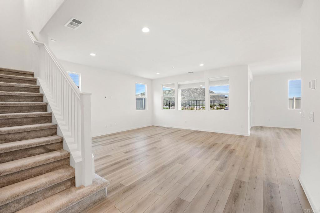 5384 Viewstone Court Hemet, CA 92545 - Photo 6 of 47 a view of an empty room with wooden floor and a window