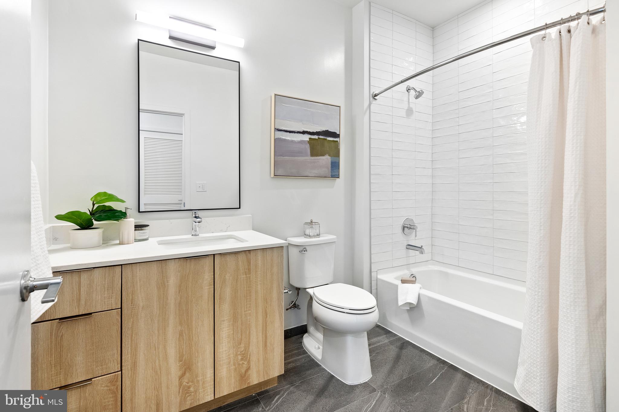 7175 12th Street Northwest, Unit 614 Washington, DC 20012 - Photo 5 of 23 a bathroom with a sink toilet and shower
