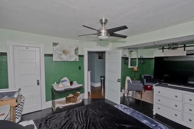 a bedroom with a bed mirror and window