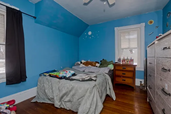 a bedroom with a bed and a dresser in it