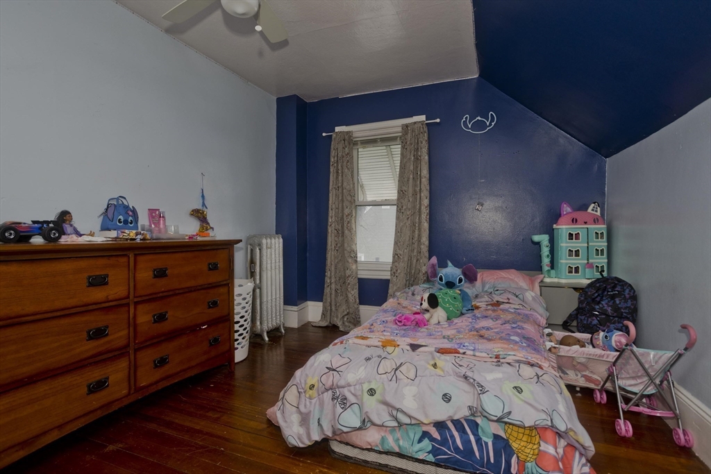 41 Embury Street Springfield, MA 01109 - Photo 25 of 41 a bedroom with a bed and a dresser in it