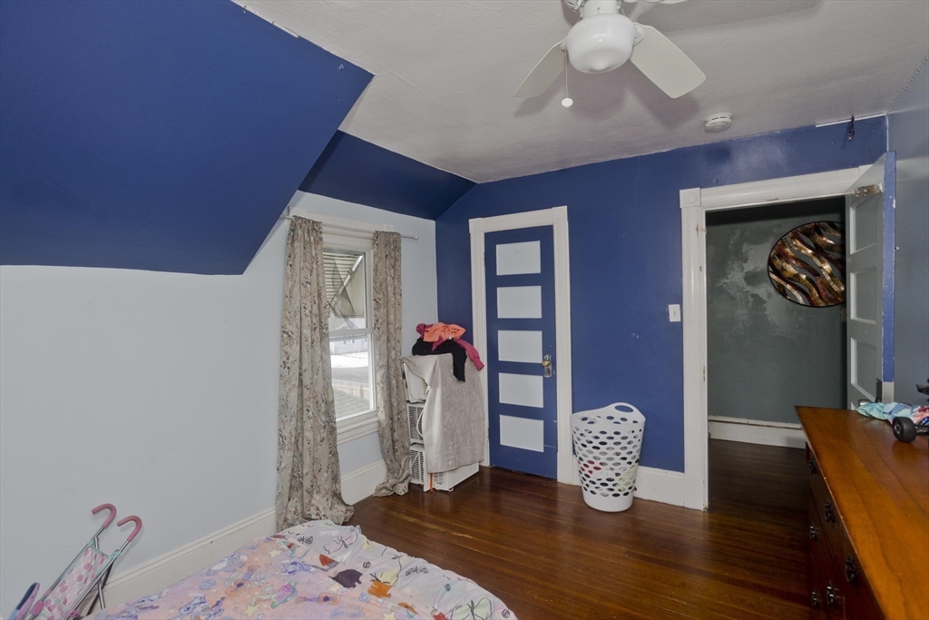 41 Embury Street Springfield, MA 01109 - Photo 26 of 41 a bedroom with bed and a wooden floor