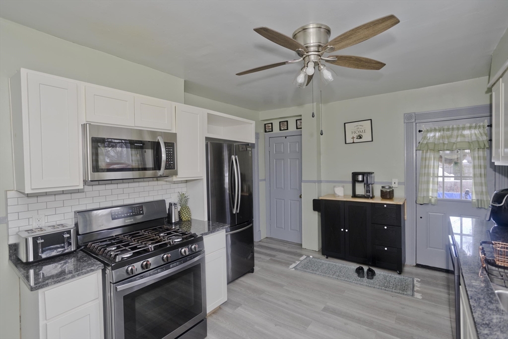 41 Embury Street Springfield, MA 01109 - Photo 29 of 41 a kitchen with stainless steel appliances granite countertop a stove a refrigerator and a microwave