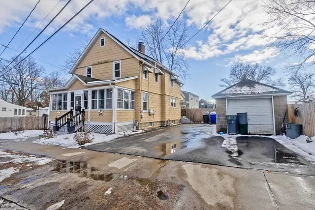 a view of a house with snow on the road
