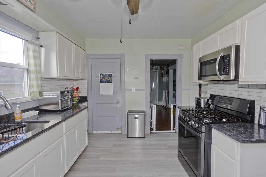 41 Embury Street Springfield, MA 01109 - Photo 31 of 41 a kitchen with stainless steel appliances granite countertop a stove a sink and a refrigerator