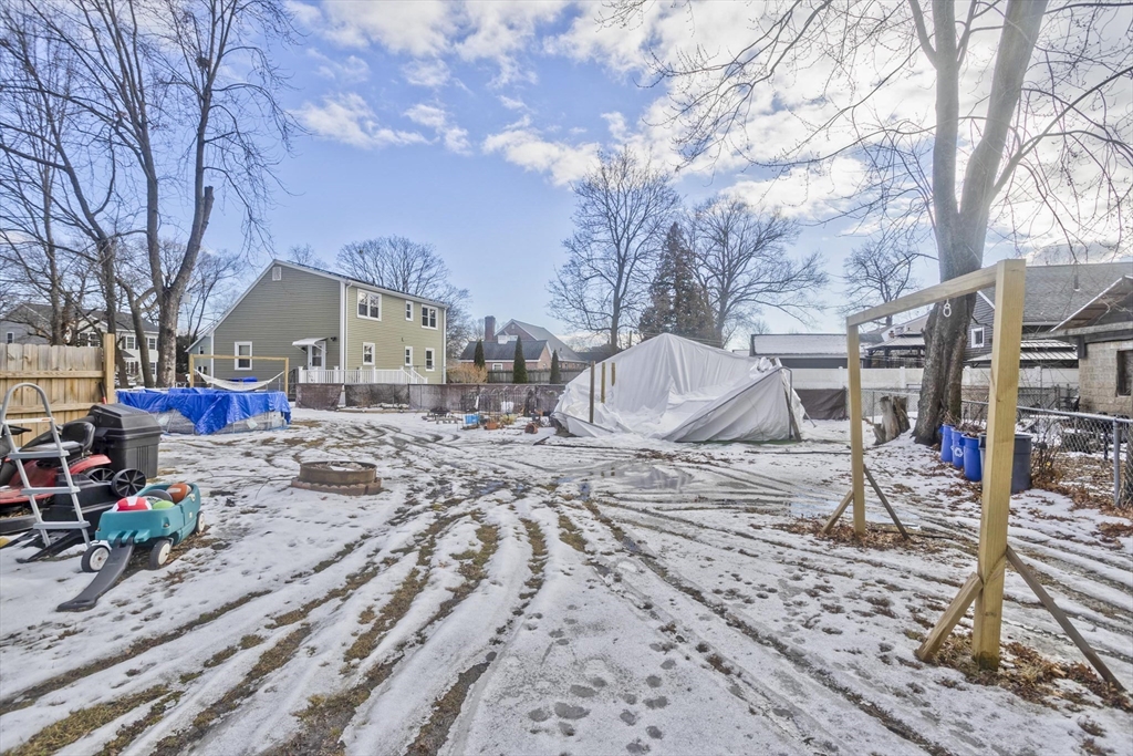 41 Embury Street Springfield, MA 01109 - Photo 4 of 41 a backyard of a house with fire pit and trees