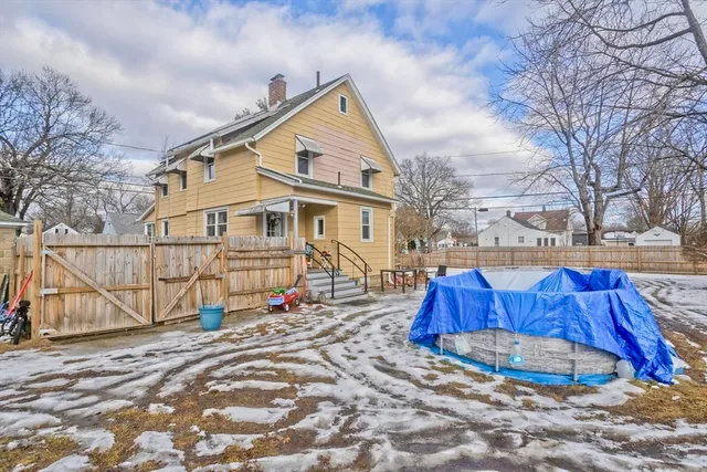 a view of a house with wooden fence