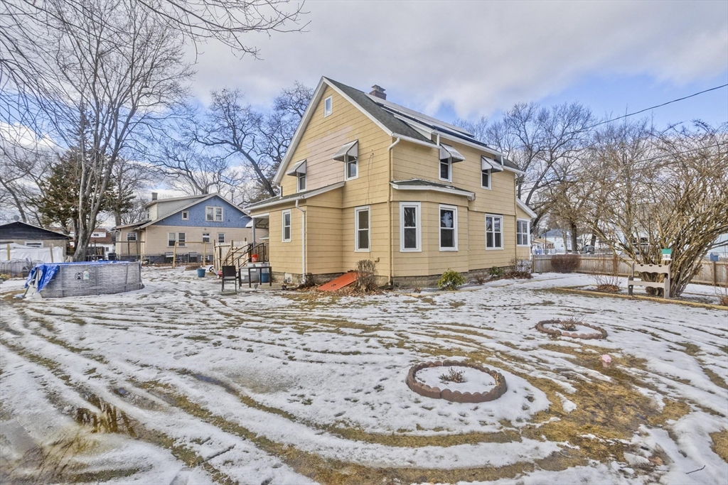 41 Embury Street Springfield, MA 01109 - Photo 10 of 41 a view of a white house with a yard covered in snow