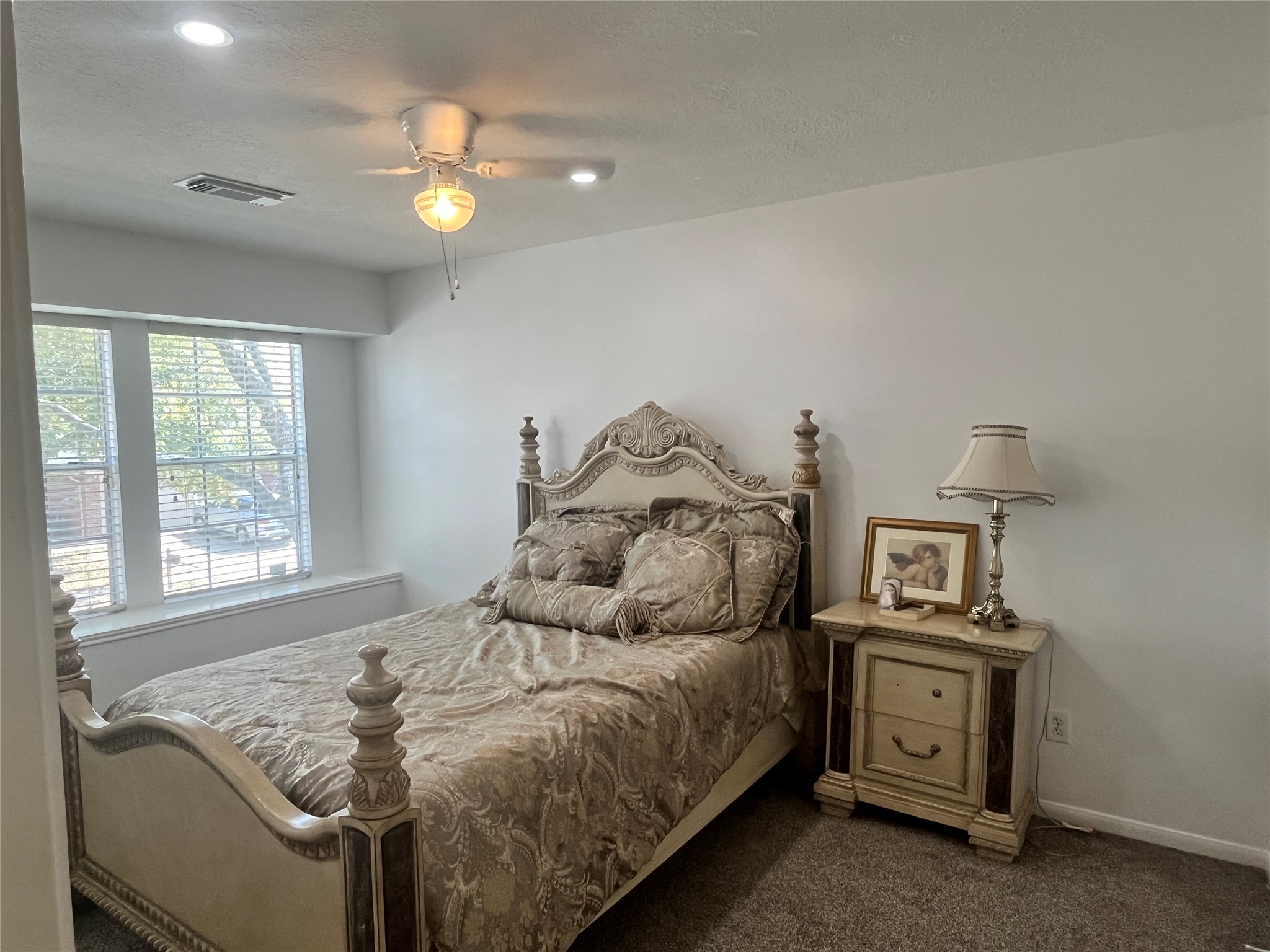 28723 Sedgefield Street Spring, TX 77386 - Photo 16 of 27 a bedroom with a bed and a chandelier