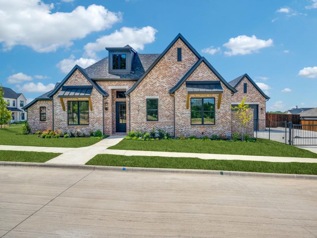 a front view of a house with a yard and trees