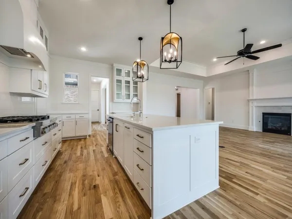 a kitchen with cabinets a sink and appliances