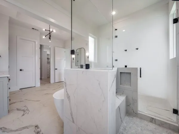 a spacious bathroom with a double vanity sink mirror and bathtub