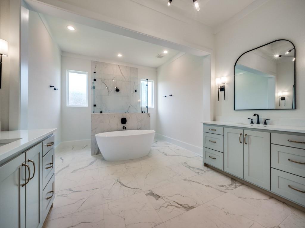 301 Fairmount Court Denton, TX 76210 - Photo 17 of 28 a spacious bathroom with a double vanity sink mirror and bathtub