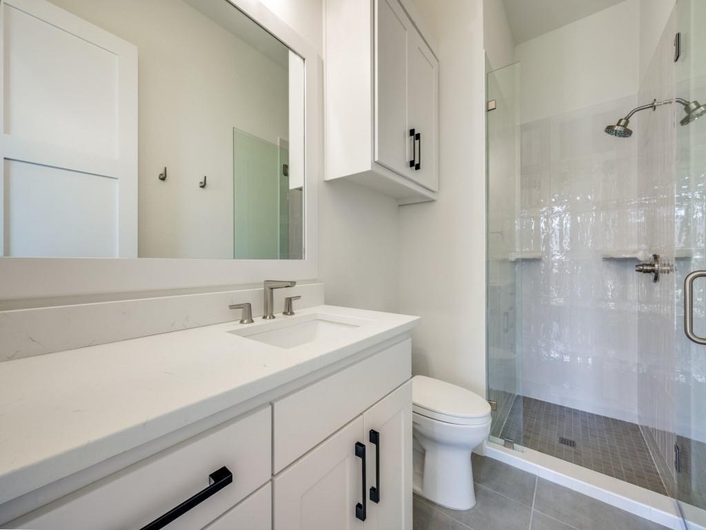 301 Fairmount Court Denton, TX 76210 - Photo 18 of 28 a bathroom with a sink a toilet and shower
