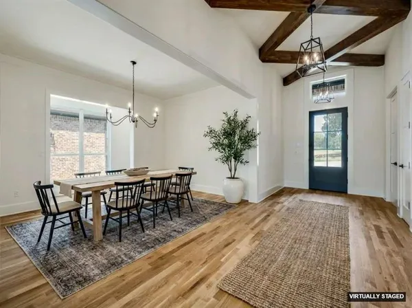 a dining room table chair and white cabinets
