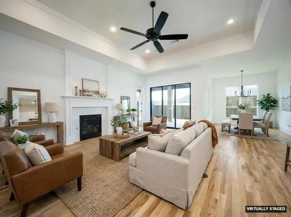 a living room with furniture and wooden floor