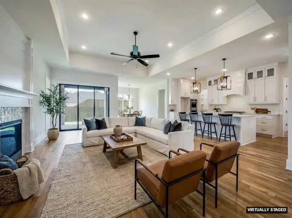 a bedroom with a large bed a large window and a chandelier