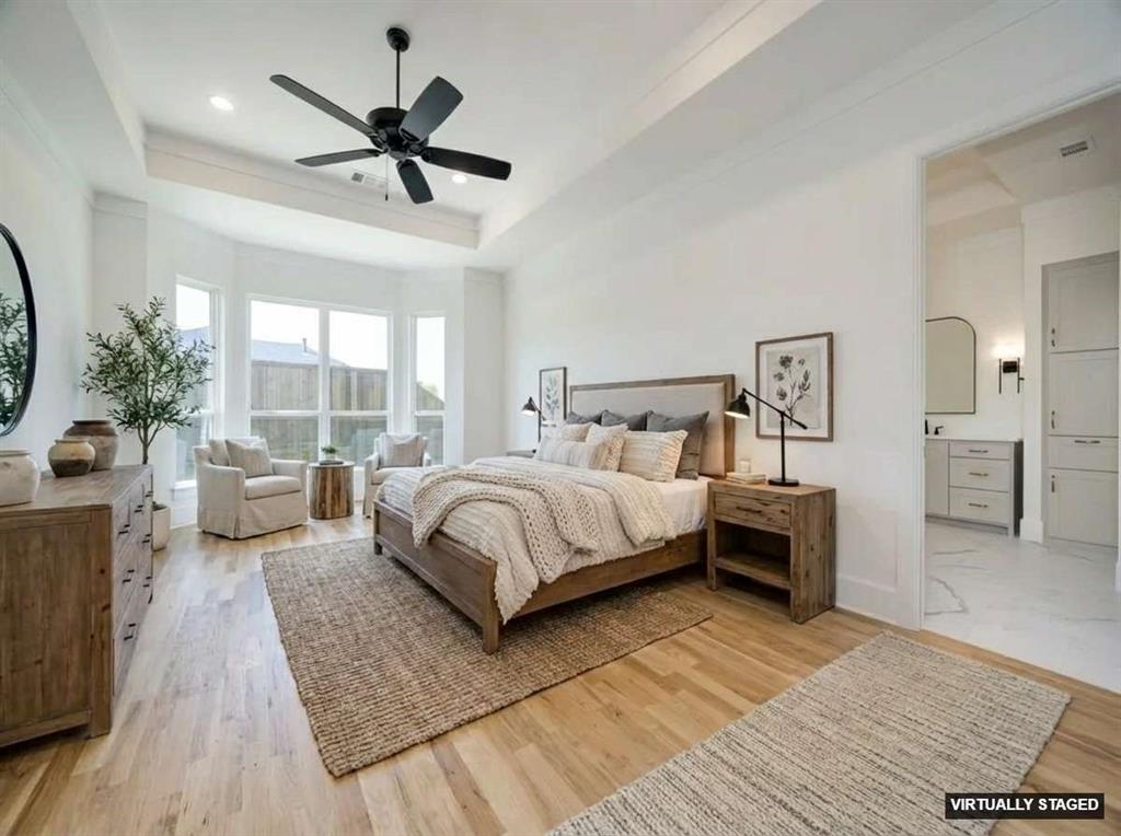 301 Fairmount Court Denton, TX 76210 - Photo 27 of 28 a bedroom with a large bed a large window and a chandelier