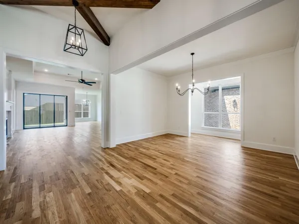 a view of a room with wooden floor and window