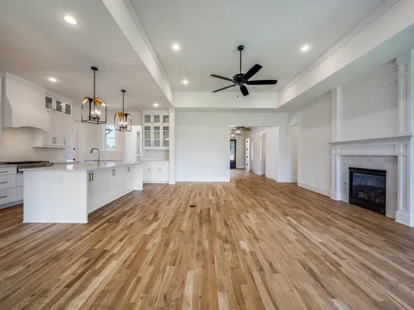 a large kitchen with kitchen island a sink stainless steel appliances and cabinets