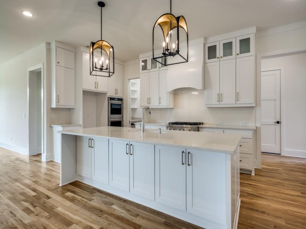 301 Fairmount Court Denton, TX 76210 - Photo 9 of 28 a kitchen with stainless steel appliances granite countertop a sink a stove and cabinets