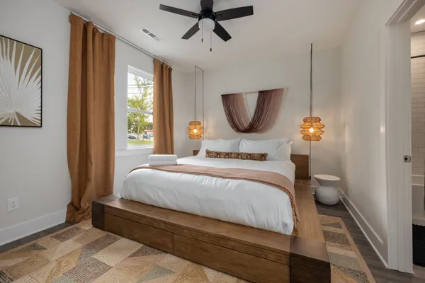 a bedroom with a bed and a chandelier