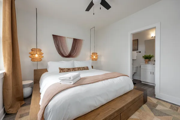 a bedroom with a bed and a chair