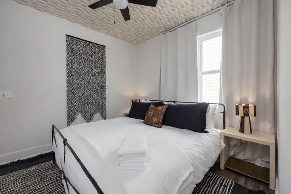 a bedroom with a bed and wooden floor