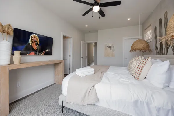 a bedroom with a bed and a painting on the wall