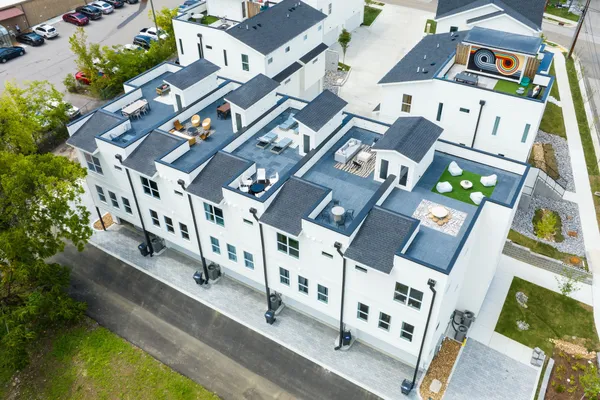an aerial view of residential building with parking