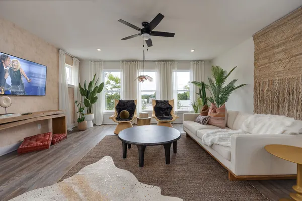 a living room with furniture potted plant and a fireplace