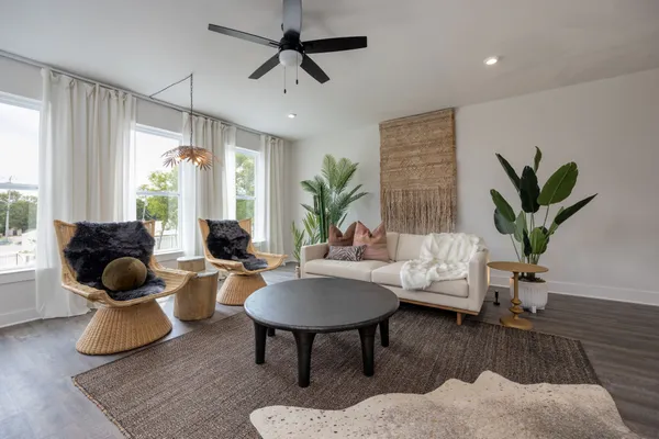 a living room with furniture and a potted plant