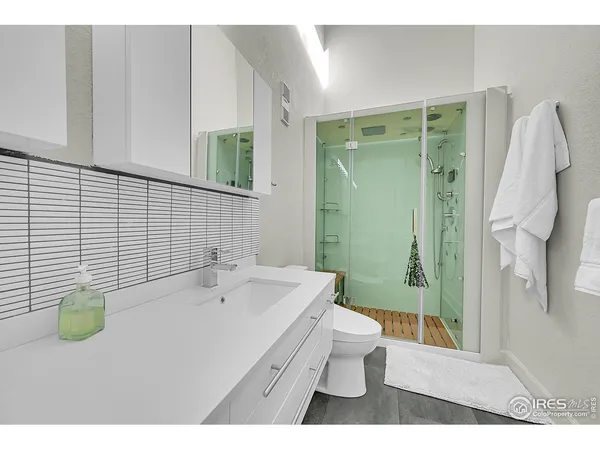 a bathroom with a sink mirror and toilet