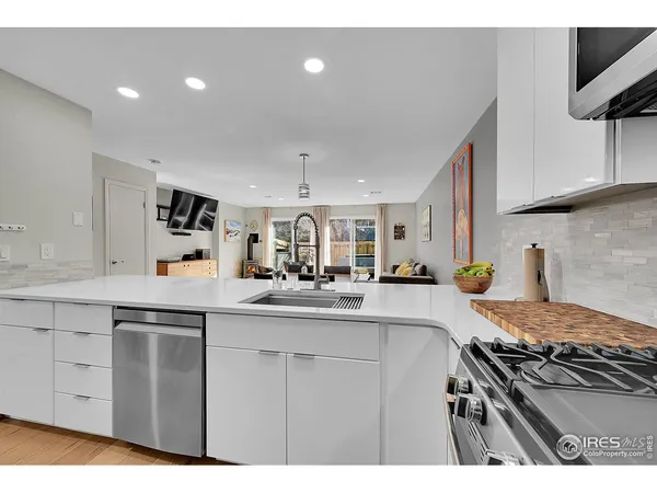 a kitchen with kitchen island a sink stove and cabinets