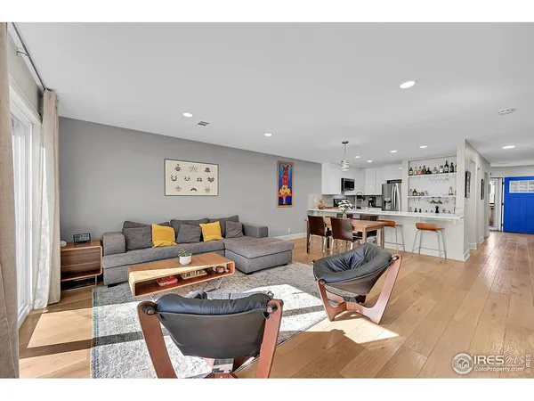 a living room with furniture and kitchen view