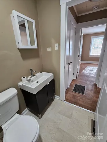 a bathroom with a toilet sink and mirror