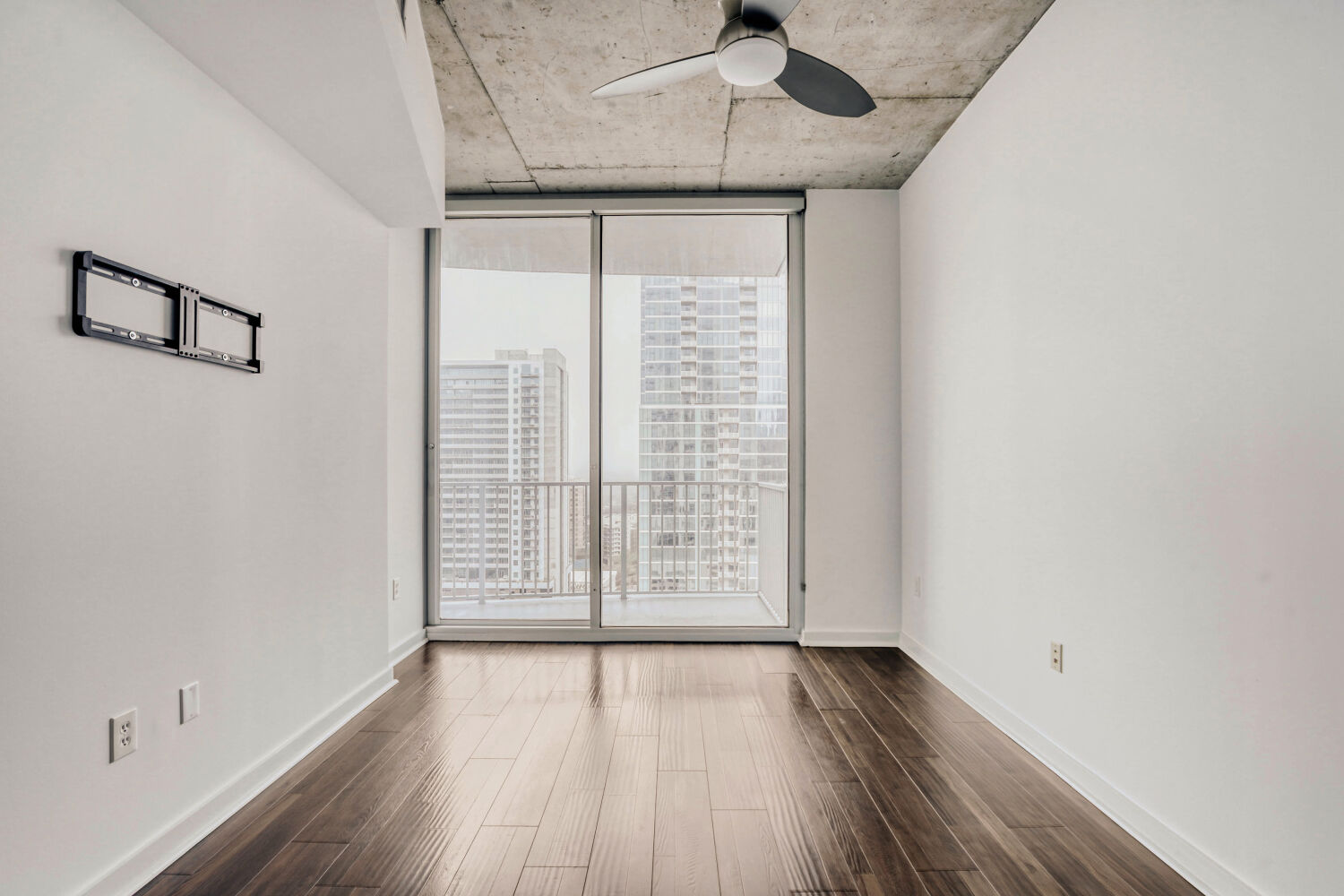 360 Nueces Street, Unit 2004 Austin, TX 78701 - Photo 25 of 34 a view of an empty room with wooden floor and a window