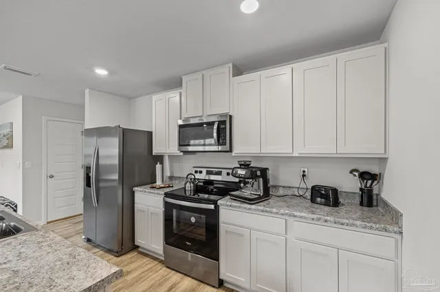 a kitchen that has a table and chairs in it