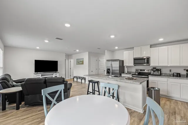 a view of a dining room with furniture and wooden floor