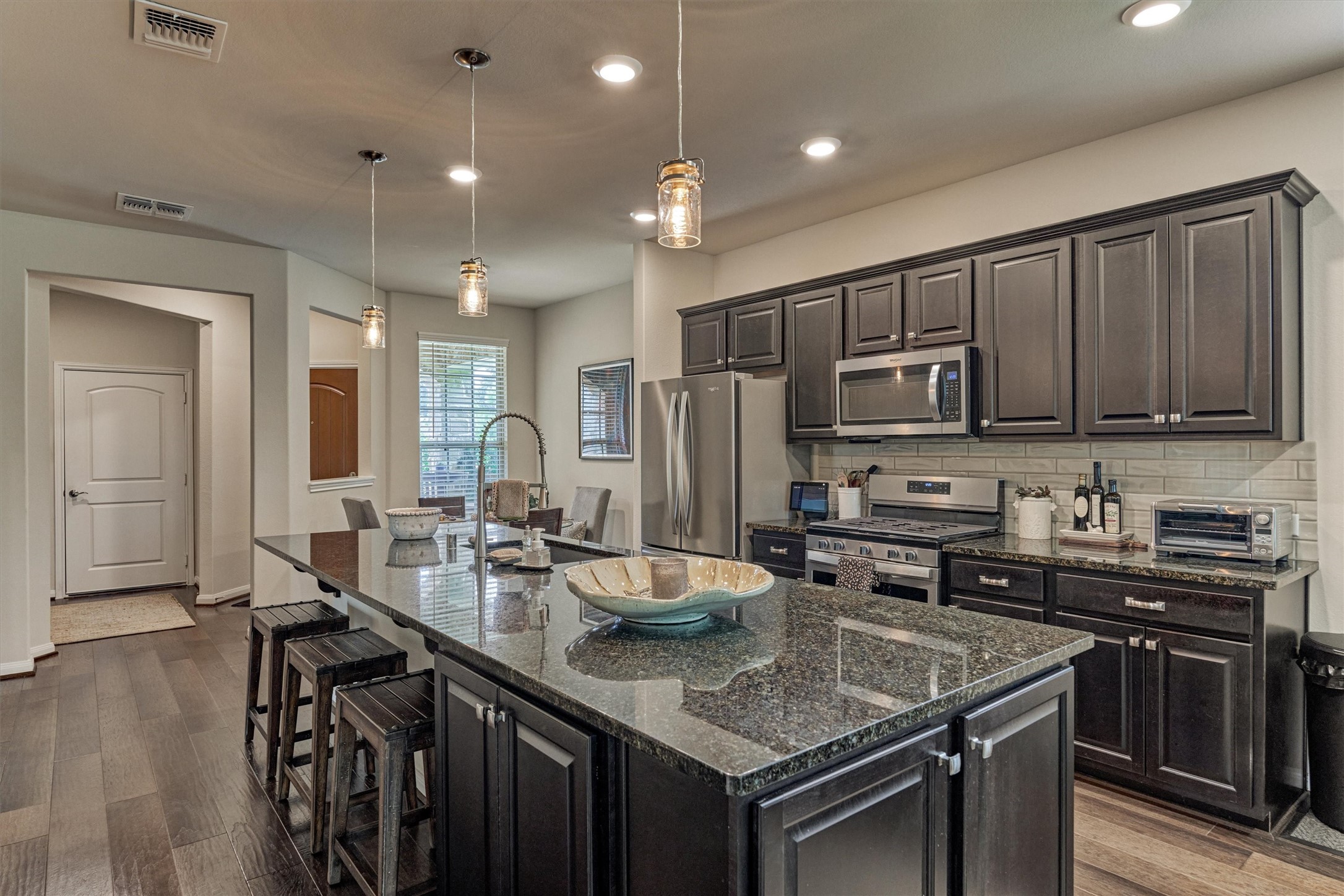 128 Caspian Way Spring Spring, TX 77382 - Photo 12 of 48 a kitchen with stainless steel appliances granite countertop a sink stove and refrigerator